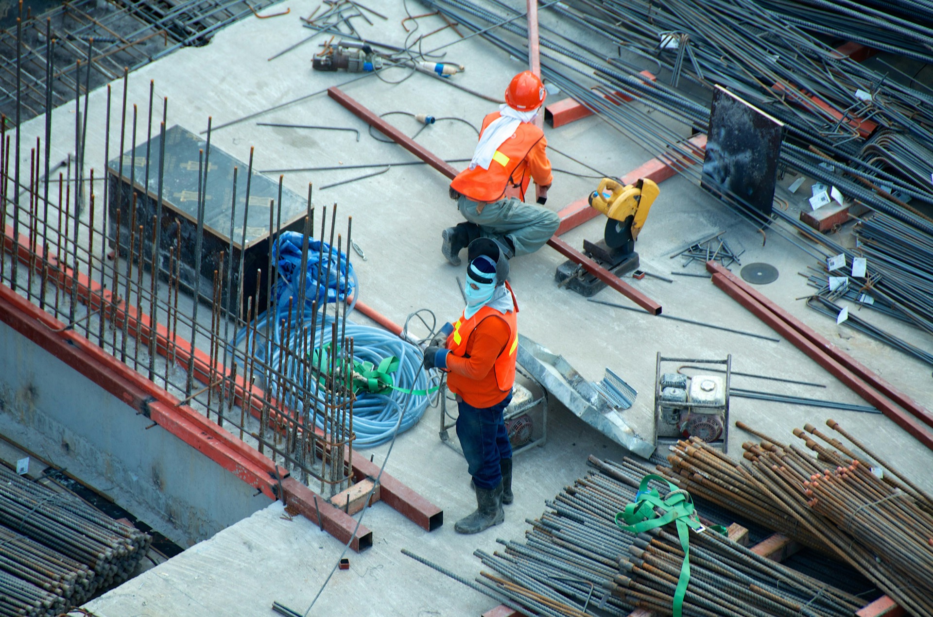 Construction workers fixing reinforcement on a concrete deck