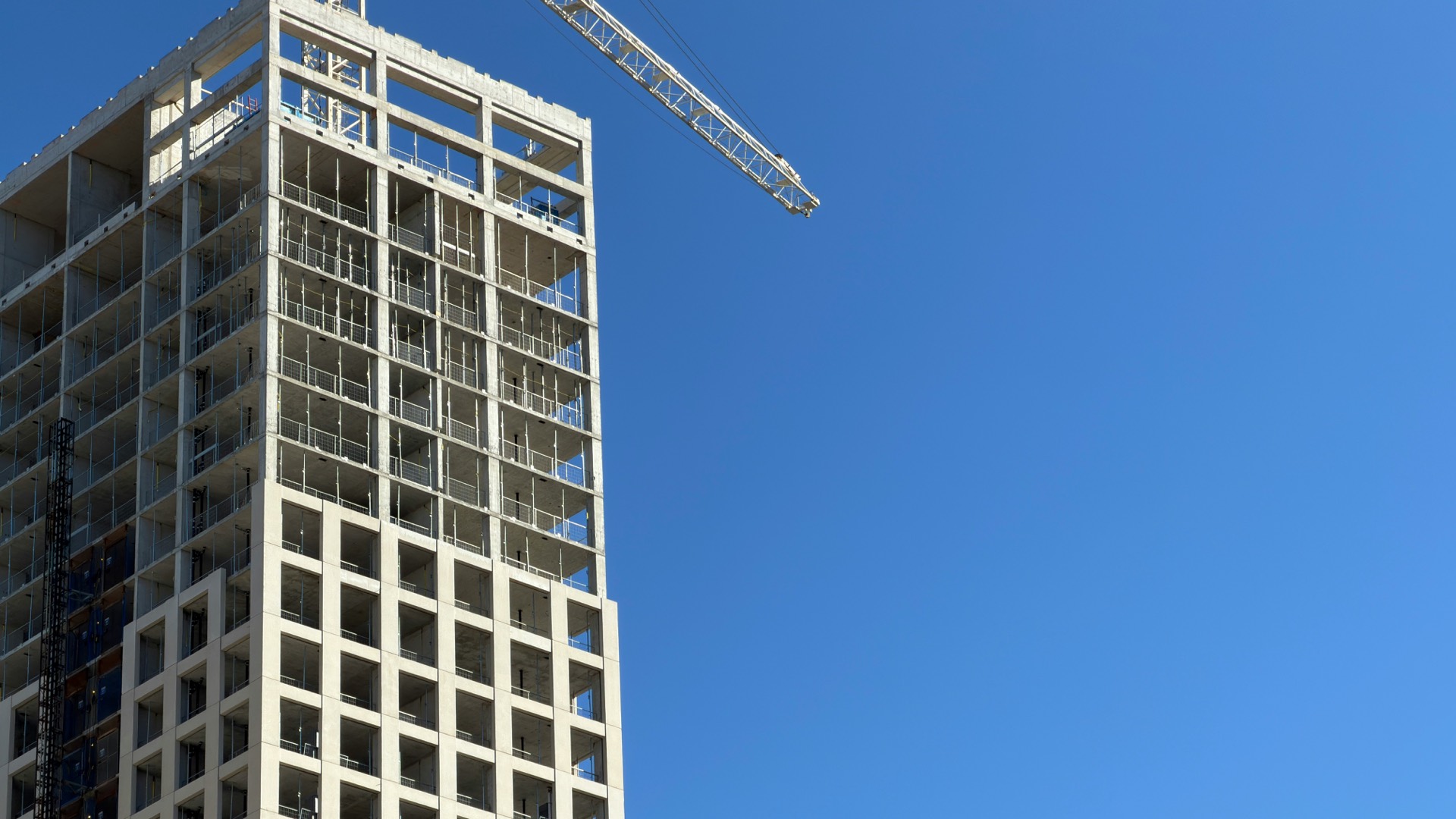 High-rise frame under construction with tower crane