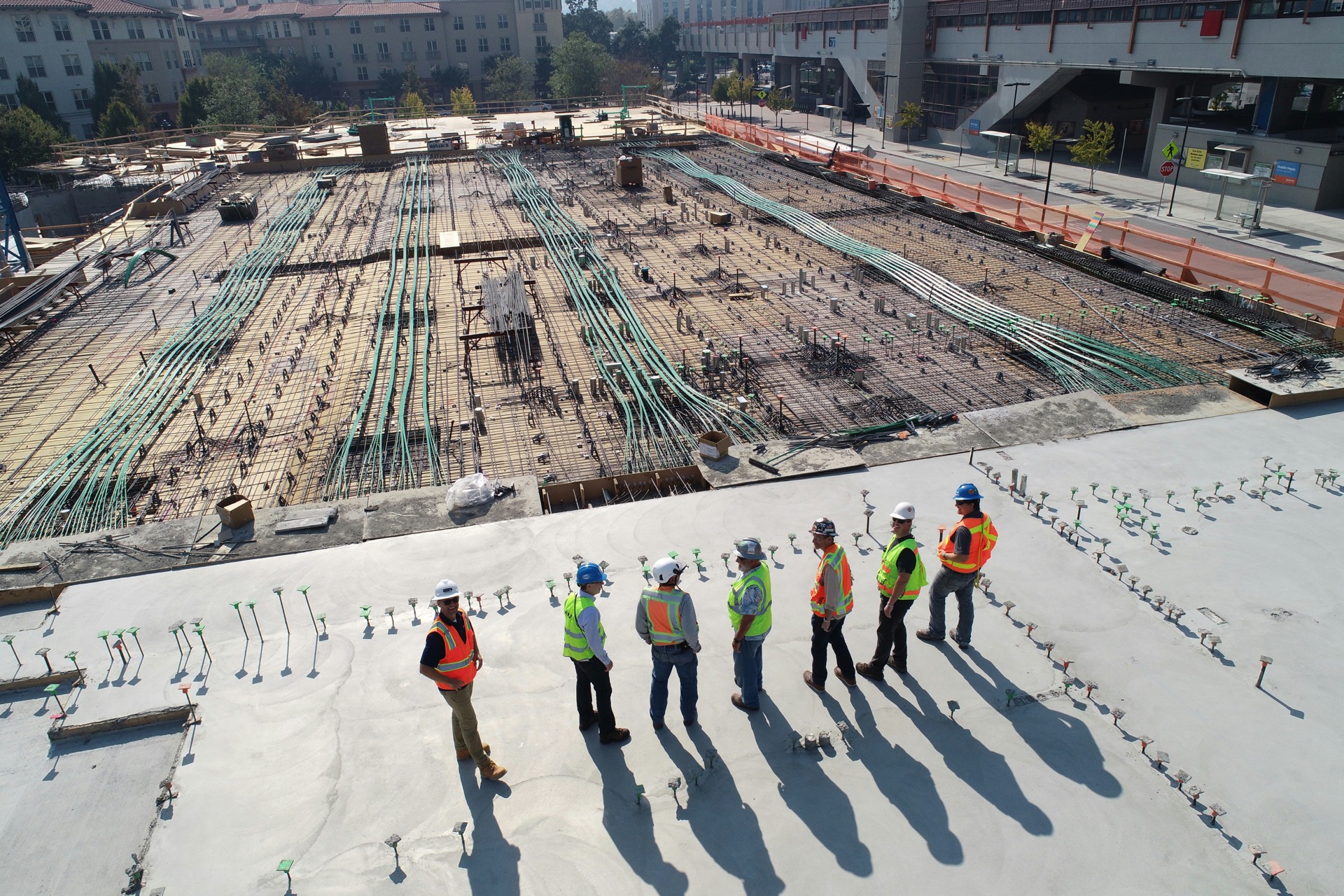 Site team standing on a large foundation slab